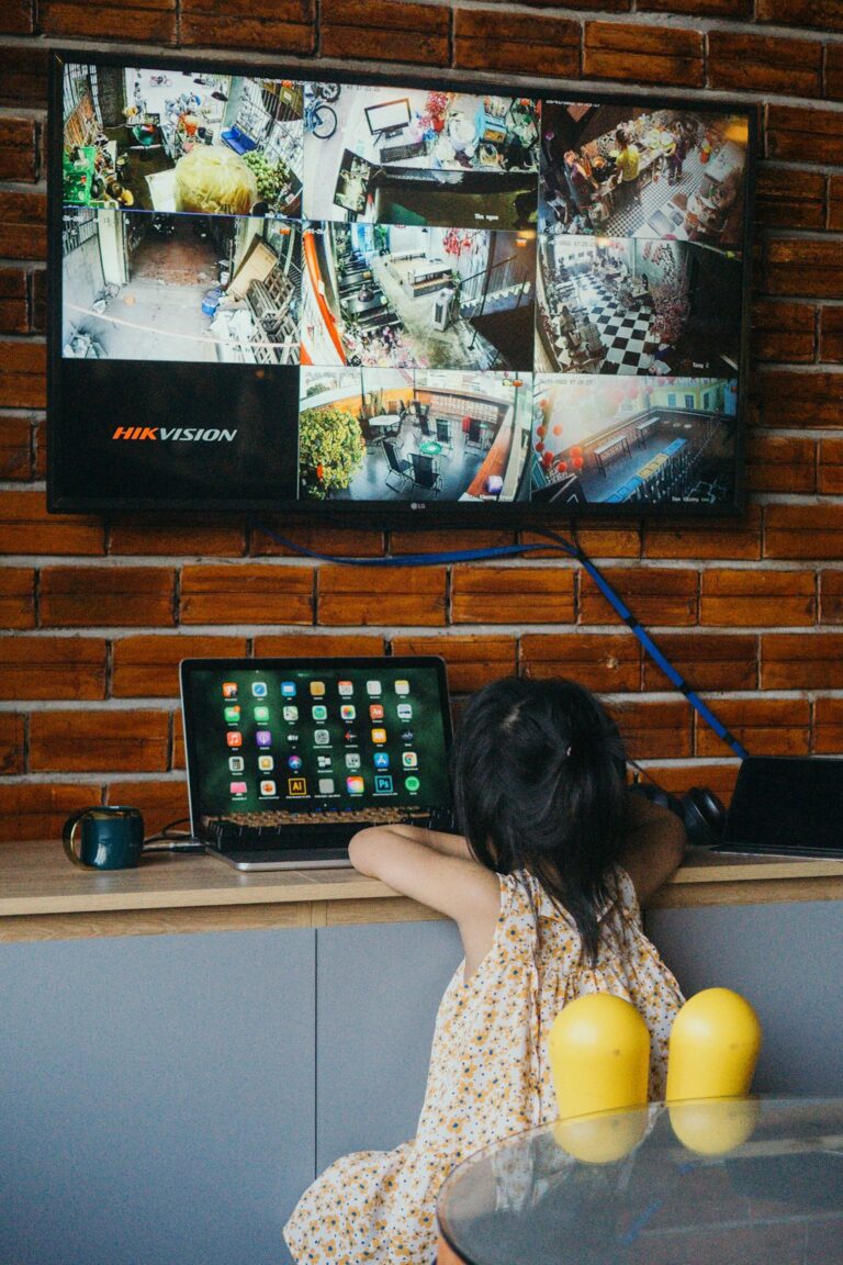 Family watches a television while a router and streaming device sit on a nearby shelf.